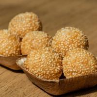 Sesame Balls (6) · Dessert dumplings made from rice flour and filled with smooth red bean paste.