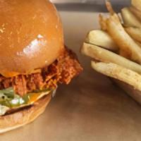 Nashville Hot Chicken · Crispy Chicken breast, cluckin' hot sauce, lettuce and pickles. Served with French Fries.