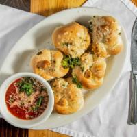 Garlic Knots · Pizza dough tied into (five) knots, covered in roasted garlic butter and topped with Parmesa...