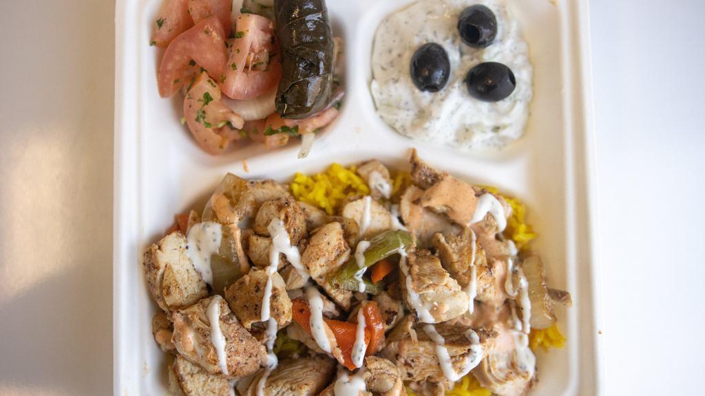 Chicken Over Rice · Long-grain basmati or yellow rice served with chopped chicken and Greek salad.