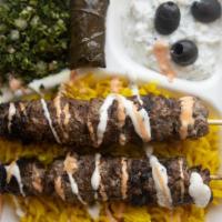 Kafta Over Rice · Long-grain basmati or yellow rice served with grilled ground lamb and beef rissole and Greek...