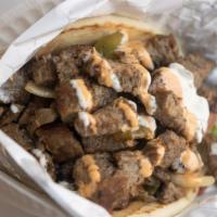 Lamb Gyro · Slow roasted lamb slices, seasoned with our special Mediterranean spices topped with tzatzik...