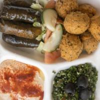 Vegetarian Plate · A combination of hummus, falafel, dolma, Greek salad and pita bread with a choice of spinach...