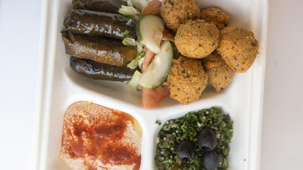 Vegetarian Plate · A combination of hummus, falafel, dolma, Greek salad and pita bread with a choice of spinach pie or cheese pie.