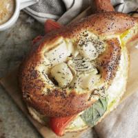 Bialy Egg Sandwich · Brioche Bialy baked with roasted sweet onions and poppy seeds, layered with two fried eggs, ...