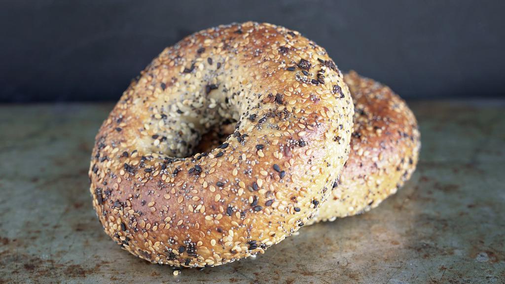 Everything Bagel · Our organic naturally-leavened bagels are hand-rolled, given a long ferment, and have just a hint of rye, which adds to their depth of flavor. The caramelized crust has a glossy sheen and the airy interior has a tight, springy crumb that balances the mild tang of sourdough with just enough malty sweetness. Topped with sesame seeds, poppy seeds, garlic and onion.