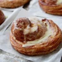 Orange Hazelnut Pinwheel (Each) · Our croissant dough rolled with roasted hazelnuts and topped with fresh orange glaze.