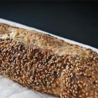 Seeded Macrina Baguette · Our version of a French baguette with a soft interior and crispy crust. Rolled in sesame, po...