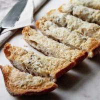 Garlic Bread · Our Batard (half) spread with garlic butter and topped with parmesan and herbs. Keep refrige...
