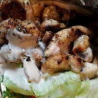 Chicken Shawarma (Gyro) · Sliced chicken served on pita bread with lettuce, onion, parsley, tomato and tahini sauce. A...
