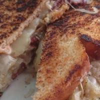 Reuben Sandwich · Pastrami grilled with thousand island, swiss cheese, and sauerkraut. Served on white bread.