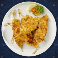 Chicken Satay · (4 Pieces) Skewered grilled chicken marinated in Thai curry and coconut milk, served with cu...