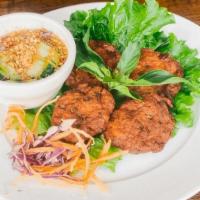 Tod Mun · Spicy fish cake made with red curry paste, green bean, and kaffir leaves. Deep fried and ser...