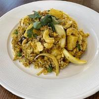 Pineapple Fried Rice · Stir-fried Jasmine rice with pineapple, egg, carrots, peas, yellow curry powder, raisins, ca...