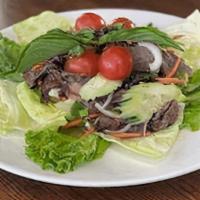 Yum Neau (Beef) · Grilled sliced beef tossed with red onion, cucumber, tomatoes, green onion and cilantro.