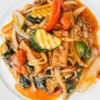 Phad Ped  · Zucchini, tomatoes, bell pepper, mushrooms, bamboo shoots, and Thai basil, in red curry past...