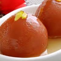 Gulab Jamun (2 Pieces) · Deep-fried sweet milk balls dipped in a rose water sugar syrup  garnished with almonds.
