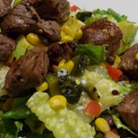 Steak Salad · Romaine lettuce topped with marinated grilled steak tips, , diced tomato, roasted corn, avoc...