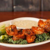 No-Bone Wings · Densely breaded chicken breast fritters that soak up the sauce of your choice.  Served with ...