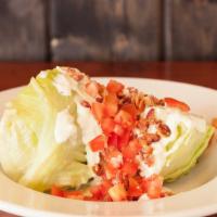 Kibbey'S Wedge · A thick wedge cut of fresh iceberg lettuce topped with chopped pepper bacon, tomato and hous...