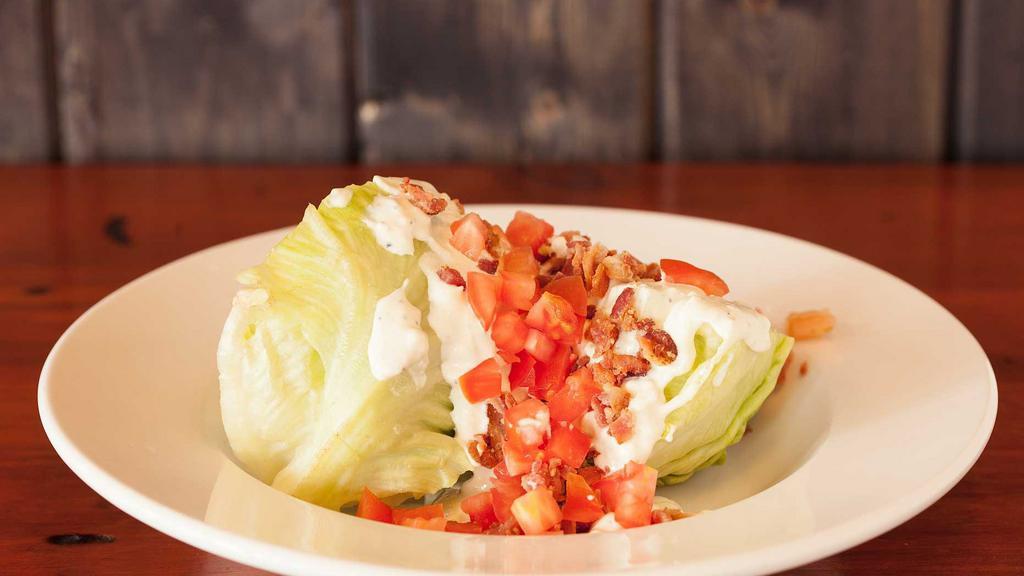 Kibbey'S Wedge · A thick wedge cut of fresh iceberg lettuce topped with chopped pepper bacon, tomato and housemade bleu cheese dressing.