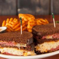 The Reuben · Our world famous sando on thick cut dark rye corned beef, sauerkraut, swiss cheese, and our ...