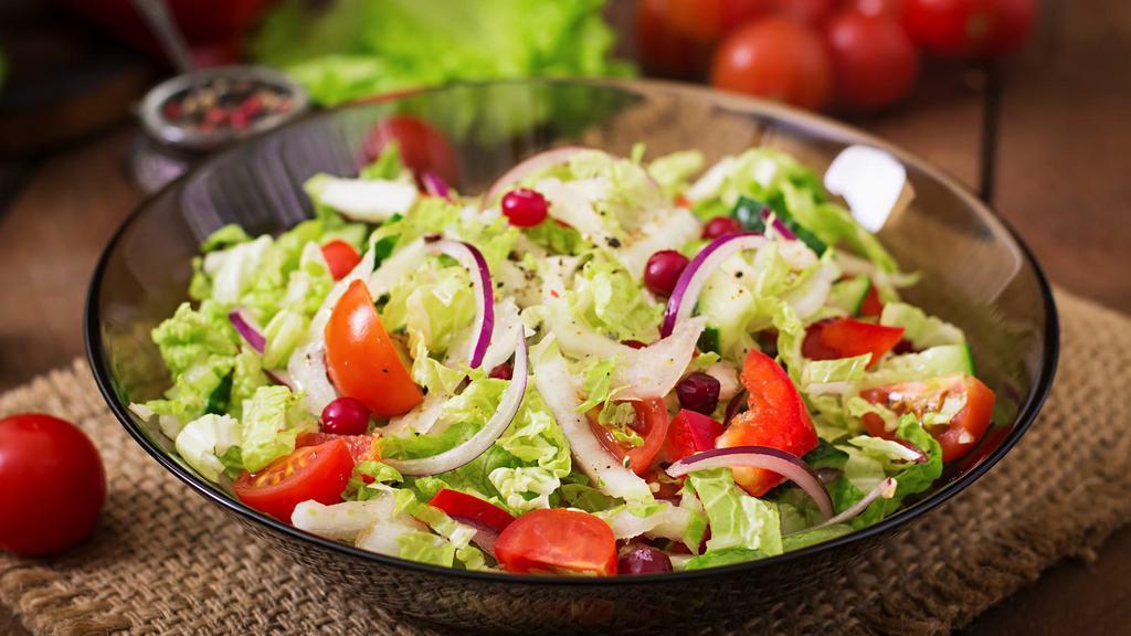 Simple Side Salad · Herbed lettuce with tomatoes, red onions and dressing.