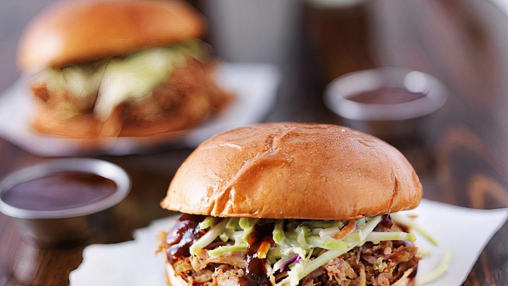 Pulled Pork Sandwich · Juicy marinated pulled pork on a brioche bun and house sauce on the side.