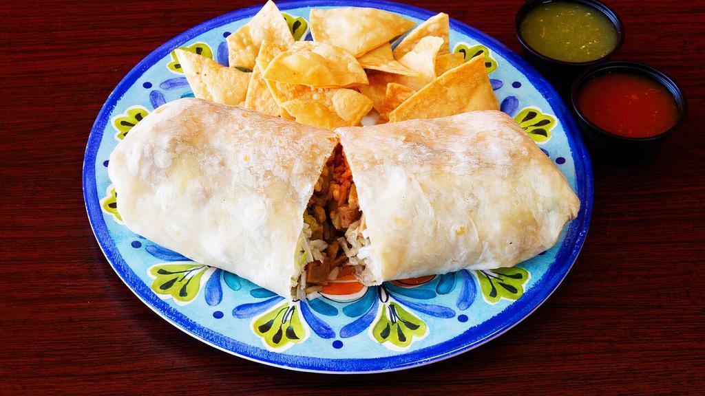 Vegan Steak Supreme Burrito · Burrito Served with Pinto Beans, Spanish Rice, Lettuce, Vegan Cheese and Sour Cream, and Vegan Steak with Grilled Onions,