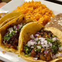 Plt:  3 Tacos, Rice & Beans · 3 Double corn tortilla tacos with your choice of meat, cilantro, onion, cabbage, rice, and y...