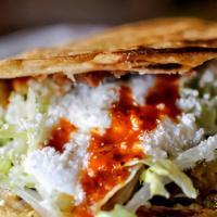 Gordita · Authentic, family recipe, stuffed corn tortilla. With your choice of meat and beans topped o...