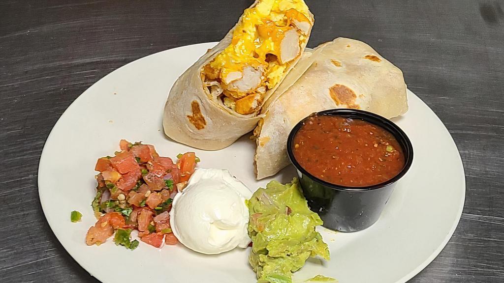 Big Breakfast Burrito · Large Garlic Herb flour tortilla filled with bacon, scrambled eggs, potatoes, cheese and a side of guacamole, pico de gallo and sour cream.
