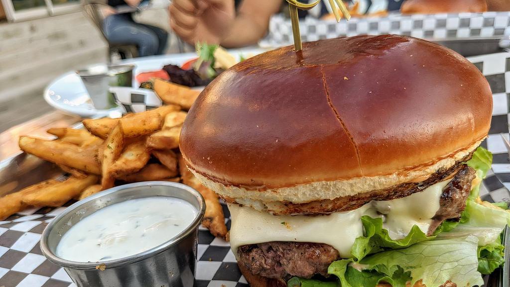 Jackalope Burger · ½ lb. beef patty, Monterey cheese, fried onions, fried egg, chipotle aioli, and lettuce on a brioche bun, served with hand-cut fries