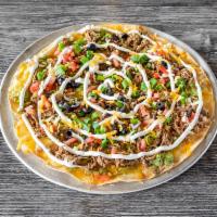 Mexican Pizza* · Large crispy flour tortilla topped with shredded beef or shredded chicken, tomatoes, green o...