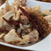 Salt & Pepper Squid · Lightly battered and slit squid with chili peppers, scallions and onions tossed in salty spi...