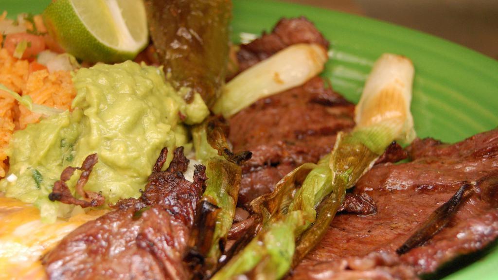 Carne Asada · Seasoned tender flame broiled skirt steak, garnished with pico de gallo, green onions and guacamole, served with tortillas.