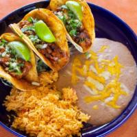 Tacos Al Pastor · 3 soft double corn tortilla tacos with barbecued pork, onions, cilantro and a special hot sa...