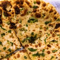 Aloo Paratha · Indian whole wheat bread filled with spiced potatoes and baked in tandoor oven.