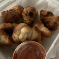 Garlic Knots 8 · Homemade dough tied in knots brushed with garlic butter, Italian herbs and grated parmesan c...