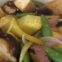 Tofu Mushrooms · Fried tofu stir-fried with shiitake mushrooms, yellow squash, snap peas, and onions.