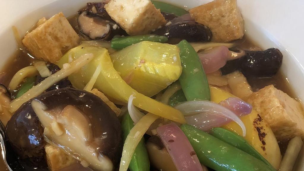 Tofu Mushrooms · Fried tofu stir-fried with shiitake mushrooms, yellow squash, snap peas, and onions.