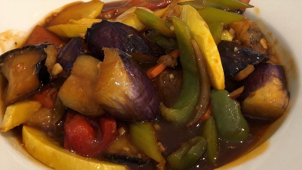 Sriracha Eggplant · Medium spicy. Eggplant cooked in world-famous sriracha hot sauce along with celery, yellow squash, carrots, bell peppers, and onions.