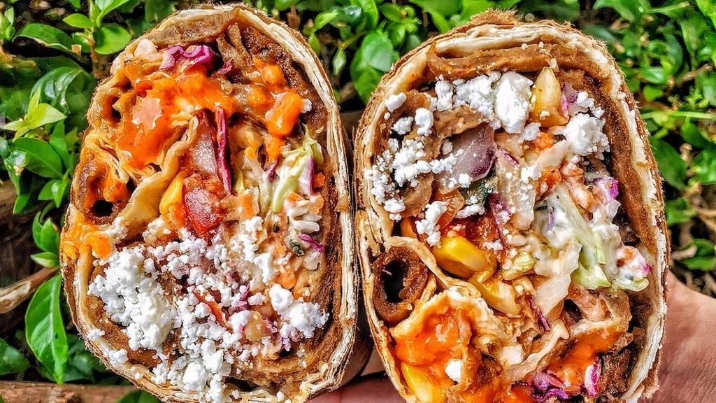 Berliner Doner Wrap · Berliner red sauce, feta, cabbage and carrot slaw, sumac, tomato, onion, cucumber, corn and tzatziki.