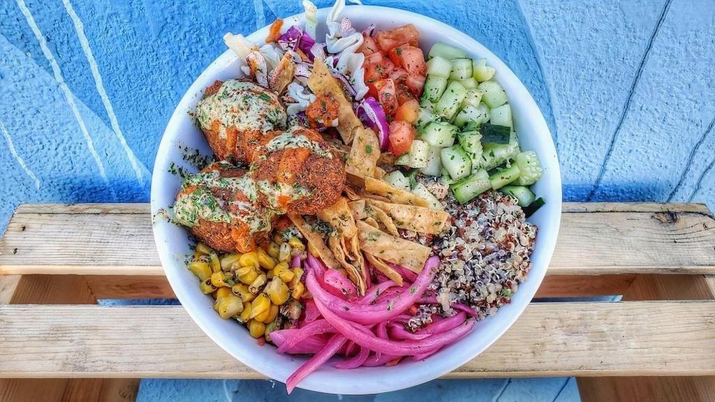 Vegan Berliner Bowl · Falafel, tahini and dill quinoa, pickled red onions and carrots, tzatziki, roasted corn, tomato, cucumber,  cabbage, berliner red sauce, lemon-herb tahini, lavash chips, and sumac.