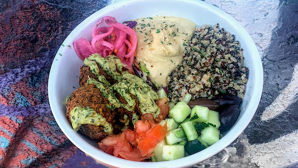 Vegan Medi Bowl · Falafel, tahini and dill quinoa, hummus, pickled red onions, tomato, cucumber, olives, lemon-herb tahini, crispy garbanzos, and za'atar.