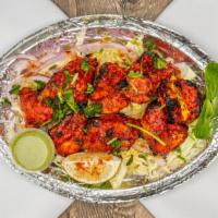 Chicken Tikka 8 Pieces · Boneless chicken breast marinated in tandoori spices and creamy yogurt and grilled.