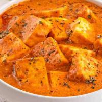 Paneer Butter Masala · Fried paneer cooked in creamy onion tomato sauce finished with mild Indian spices.