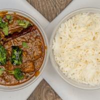 Andhra Goat Curry - Bone · Goat cooked in onion-tomato sauce finished with Indian spices.