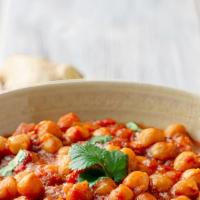Chana Masala · Chickpeas slow cooked with onion, ginger, fresh tomatoes, cilantro and spice.