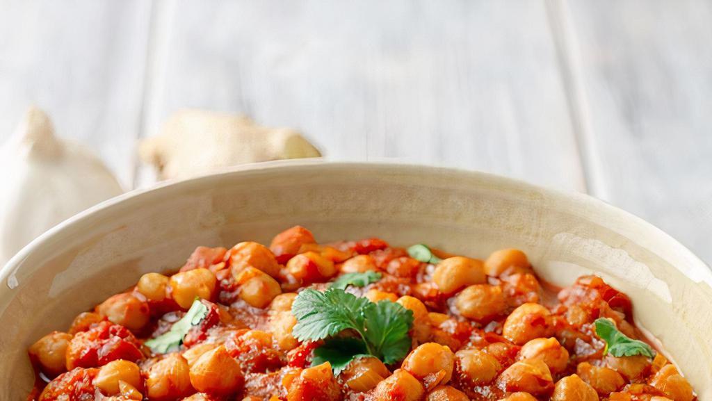 Chana Masala · Chickpeas slow cooked with onion, ginger, fresh tomatoes, cilantro and spice.